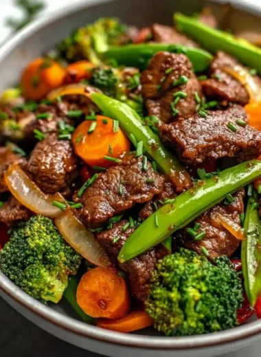 Beef stir fry with colorful vegetables in a stir-fry pan