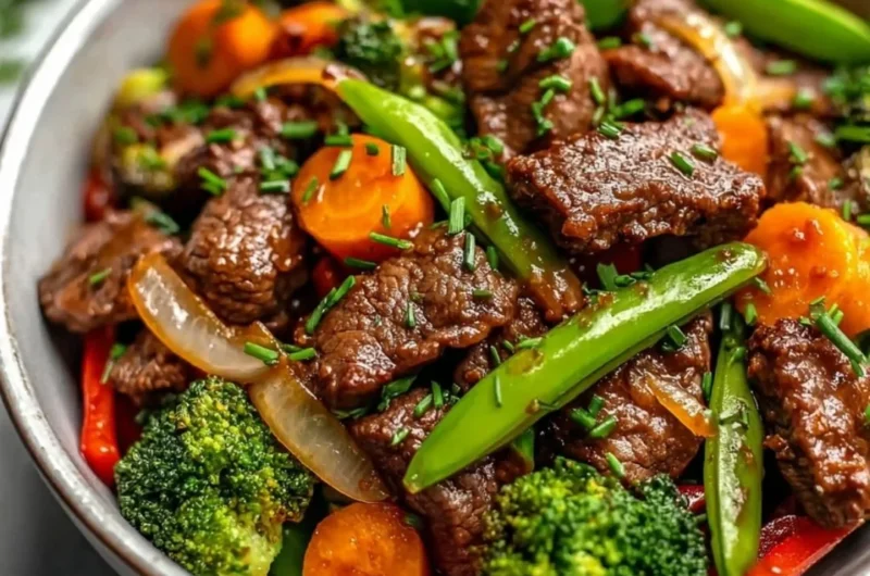 Beef stir fry with colorful vegetables in a stir-fry pan
