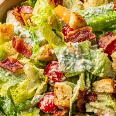 Fresh BLT salad with crispy bacon, lettuce, and ripe tomatoes served in a bowl.