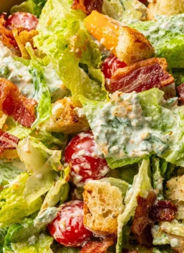 Fresh BLT salad with crispy bacon, lettuce, and ripe tomatoes served in a bowl.