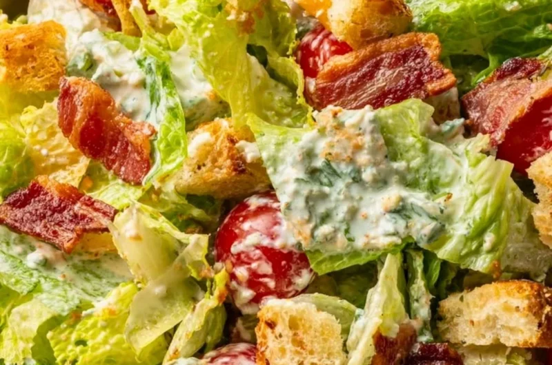 Fresh BLT salad with crispy bacon, lettuce, and ripe tomatoes served in a bowl.