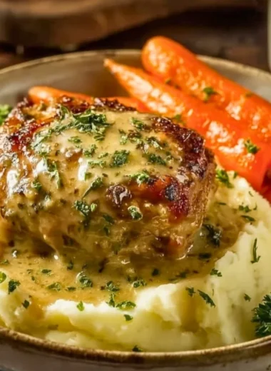 Creamy herb chicken dish with mashed potatoes and honey glazed carrots