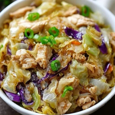 A colorful egg roll bowl featuring chicken, cabbage, and fresh vegetables.