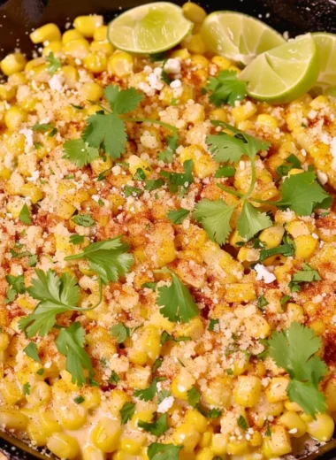 Skillet Mexican Street Corn garnished with cheese and cilantro