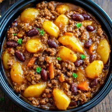 Delicious Slow Cooker Cowboy Casserole served with cheese and toppings