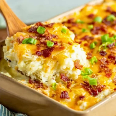 Delicious twice baked potato casserole from The Pioneer Woman, topped with cheese and green onions.