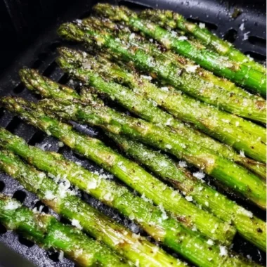 Crispy air fryer roasted asparagus served on a plate.