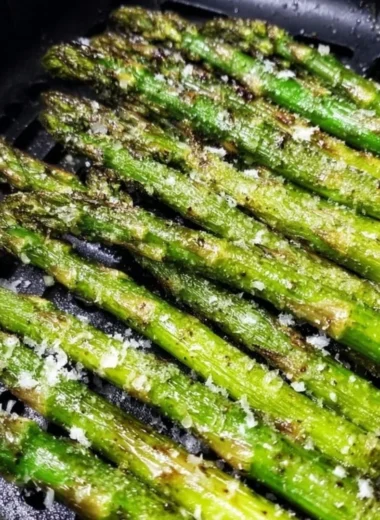 Crispy air fryer roasted asparagus served on a plate.