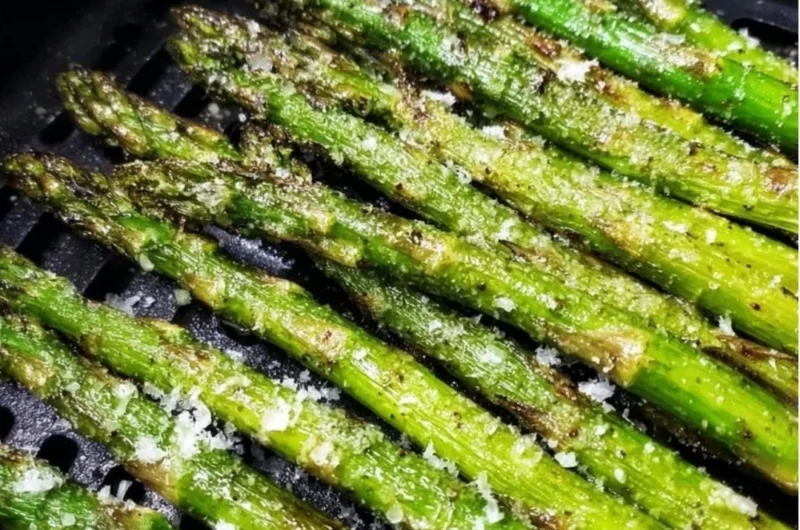 Crispy air fryer roasted asparagus served on a plate.