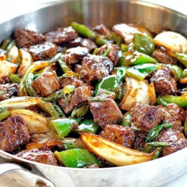 Delicious teriyaki steak bites with green pepper and onion served on a platter
