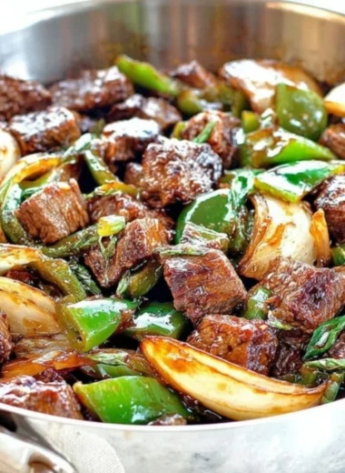 Delicious teriyaki steak bites with green pepper and onion served on a platter