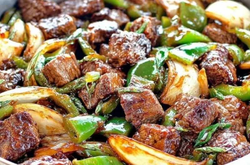Delicious teriyaki steak bites with green pepper and onion served on a platter
