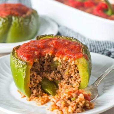 Classic stuffed peppers filled with rice, meat, and spices, topped with cheese.