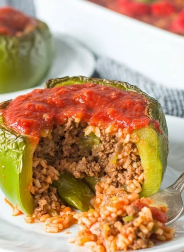 Classic stuffed peppers filled with rice, meat, and spices, topped with cheese.