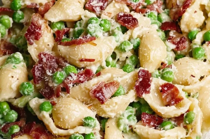 Creamy Pea and Bacon Pasta Salad served in a bowl with fresh herbs