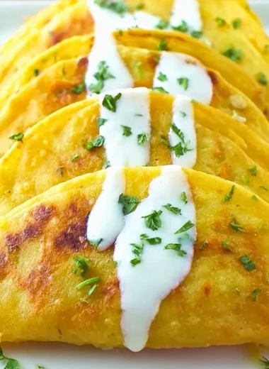 Crispy potato tacos filled with seasoned potatoes and fresh toppings
