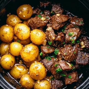 Delicious Garlic Butter Beef Bites served with crispy golden potatoes