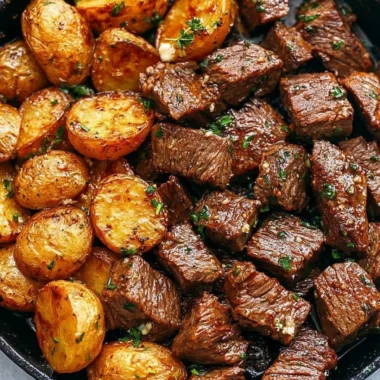 Garlic butter steak bites served with roasted potatoes