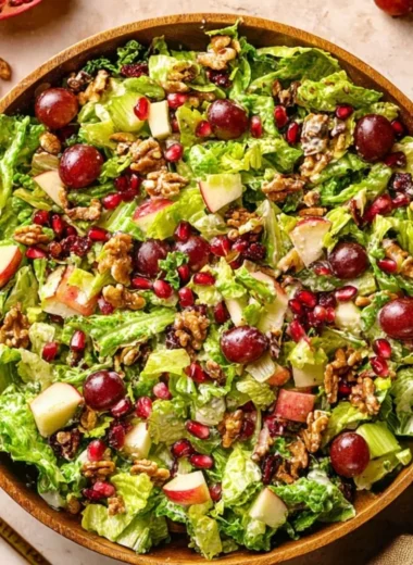 Bowl of modern Waldorf salad with apples, walnuts, and grapes