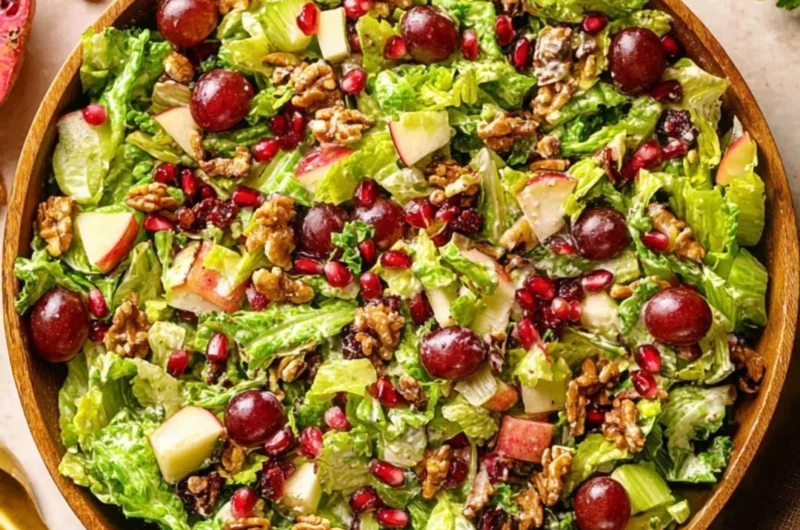 Bowl of modern Waldorf salad with apples, walnuts, and grapes