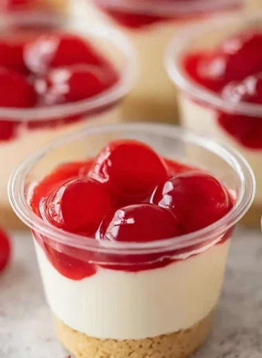 Delicious no-bake cheesecake cups topped with fresh berries and whipped cream