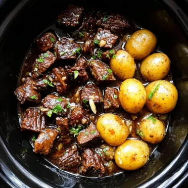 Slow cooker garlic butter beef bites served with potatoes