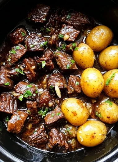 Slow cooker garlic butter beef bites served with potatoes