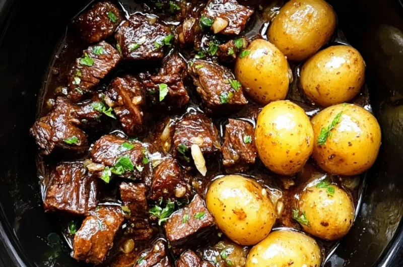 Slow cooker garlic butter beef bites served with potatoes