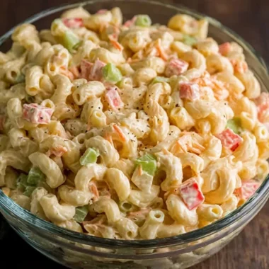 Small macaroni salad served in a bowl with fresh vegetables