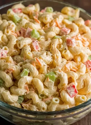Small macaroni salad served in a bowl with fresh vegetables