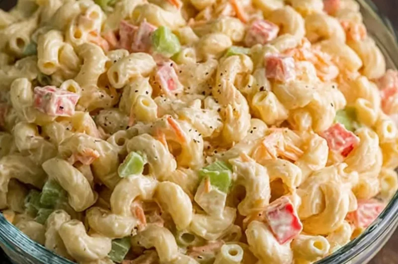 Small macaroni salad served in a bowl with fresh vegetables